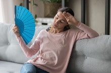 San Antonio homeowner uses a fan to try and cool off from high humidity.