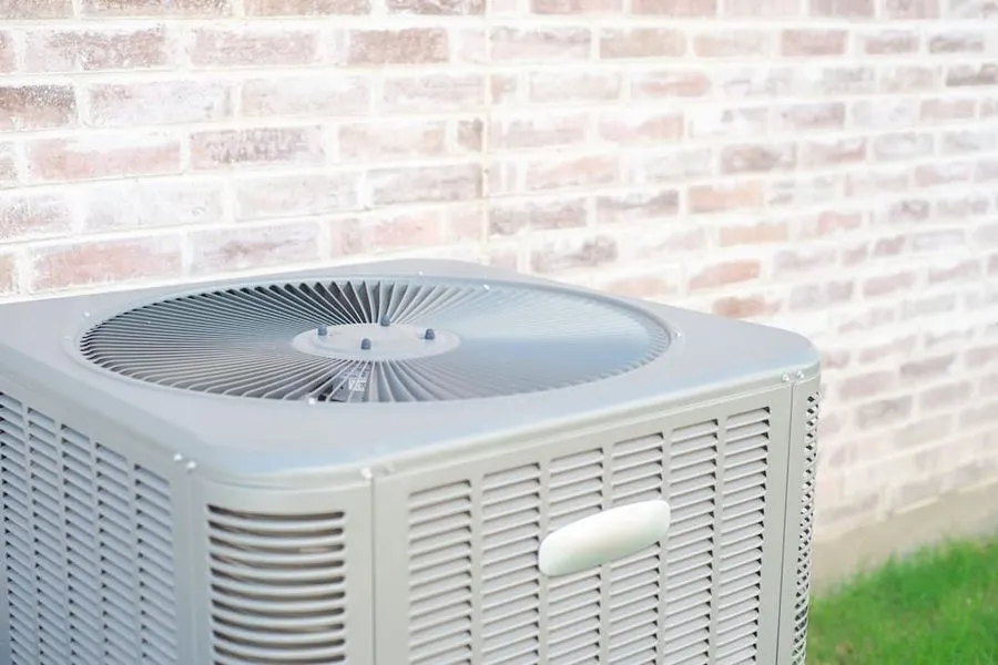 Outdoor air conditioning system on the side of a brick house